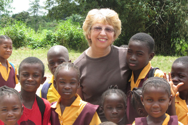 This Oct. 7, 2013, photo provided by Jeremy Writebol show his mother, Nancy Writebol, with children in Liberia. Writebol is one of two Americans working for a missionary group in Liberia who have  ...