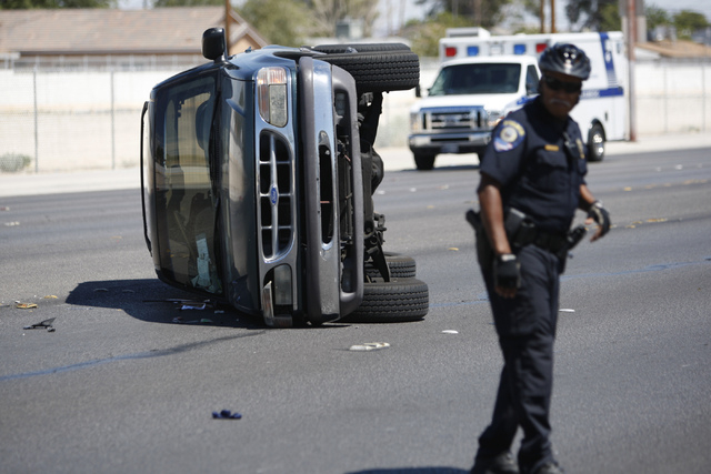 An SUV is seen flipped on its side after an accident on Lake Mead Boulevard near Tonopah Drive in Las Vegas Friday, Aug. 29, 2014. (Erik Verduzco/Las Vegas Review-Journal)