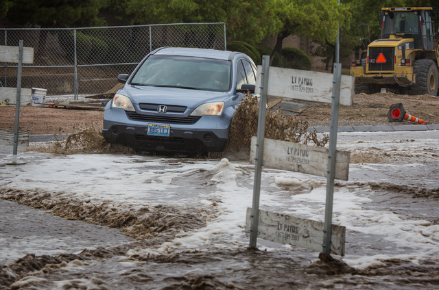 A vehicle maneuvers the flooded Grand Teton Drive in northwest Las Vegas on Monday, Aug. 4, 2014. Overnight monsoon rains caused flooding in the area.
(Jeff Scheid/Las Vegas Review-Journal)