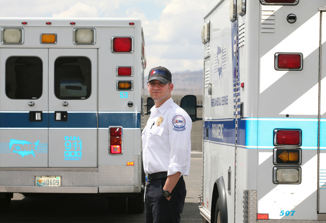 Frank Marchionne, operations supervisor and paramedic at American Medical Response, stands near two ambulances at American Medical Response Tuesday, Aug. 12, 2014, in Las Vegas. Marchionne worked  ...