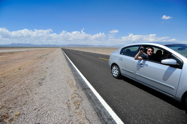 A motorist records his travels along state route 375 or the Extraterrestrial Highway, as he enters the desert town of Rachel, Nev. on Tuesday, Aug. 5, 2014. Rachel is the nearest town to the supe ...