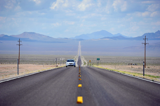 Motorists travel along state route 375 or the Extraterrestrial Highway, near the desert town of Rachel, Nev. on Tuesday, Aug. 5, 2014. Rachel is the nearest town to the super secret military base, ...