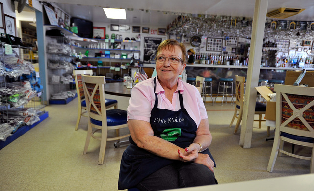 Pat Travis, owner of the Little A'Le'Inn in Rachel, Nev., sits with customers in her restaurant on Tuesday, Aug. 5, 2014. Travis has owned the bar, restaurant and motel for over 20 years and which ...