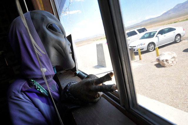 A plastic alien like creature greets visitors from a window at the Little A'Le'Inn in Rachel, Nev. on Tuesday, Aug. 5, 2014. The bar, restaurant and motel is a favorite stop for visitors of Area 5 ...