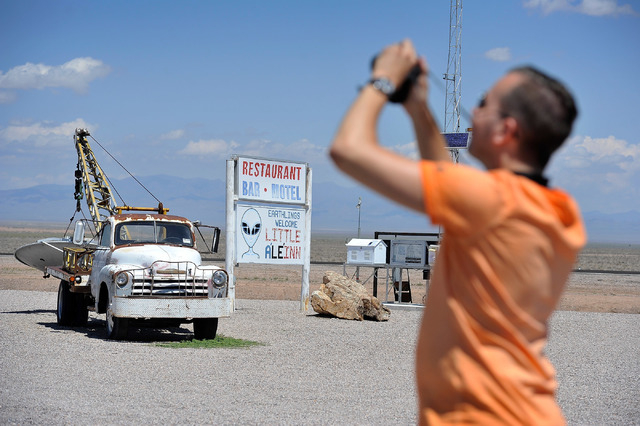 Floris Otten, of The Netherlands, photographs some of the artifacts found at the Little A'Le'Inn in Rachel, Nev. on Tuesday, Aug. 5, 2014. The bar, restaurant and motel is a favorite stop for visi ...