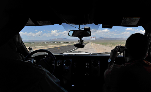 Dean Baumgartner, left, certified tour guide for Adventure Photo Tours drives up to the "Welcome to Rachel, Nevada" road sign along state route 375 or the Extraterrestrial Highway allow ...