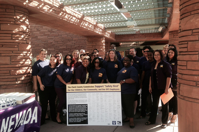 Members of the Service Employees International Union take photos on Tuesday, August 5, 2014, before presenting a petition to make improvements in the child welfare agency. (Yesenia Amaro/Las Vegas ...