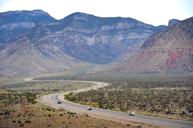 Motorists travel along Nevada Highway 160 in Red Rock Canyon National Recreation Area on Tuesday, Aug. 12, 2014. The  Bureau of Land Management is in the midst of an environmental study for a prop ...