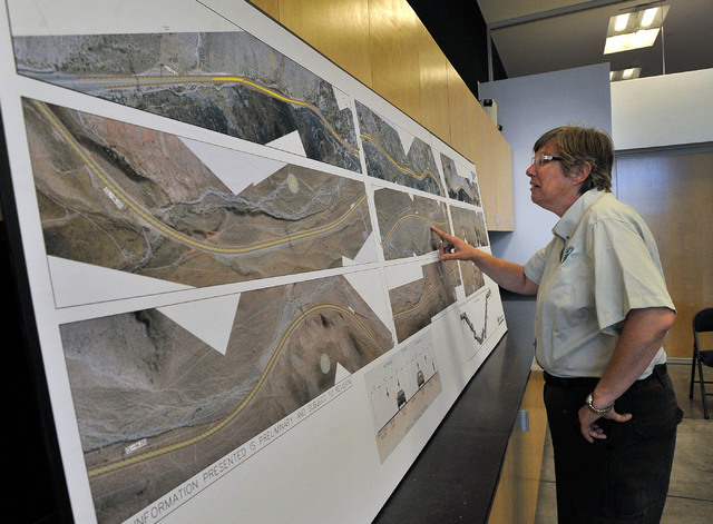 Kathy August, outdoor recreation planner for the Bureau of Land Management, reviews proposed road improvement plans during a public hearing at the Red Rock Canyon National Recreation Area visitor  ...