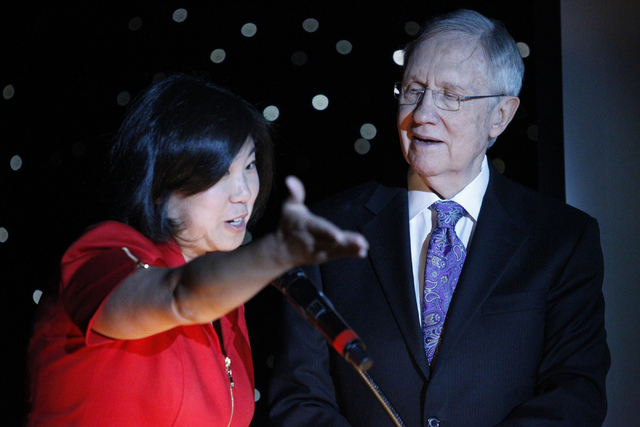 U.S. Rep. Grace Meng, D-Queens, left, and U.S. Sen. Harry Reid, D-Nev., take the stage during the Asian Chamber of Commerce's monthly lunch at the Gold Coast casino-hotel in Las Vegas Thursday, Au ...