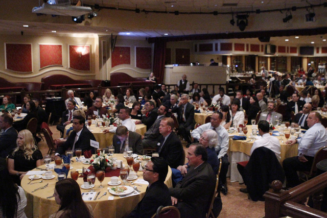 People listen to U.S. Sen. Harry Reid, D-Nev., during the Asian Chamber of Commerce's monthly lunch at the Gold Coast casino-hotel in Las Vegas Thursday, Aug. 21, 2014. (Erik Verduzco/Las vegas Re ...