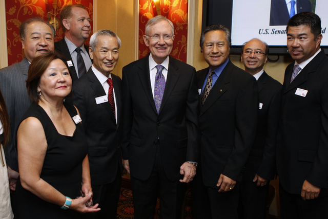 U.S. Sen. Harry Reid, D-Nev., center, takes photographs with members of the Asian Chamber of Commerce prior to taking the stage during their monthly lunch at the Gold Coast casino-hotel in Las Veg ...