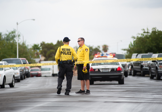 Las Vegas police officers communicate with each other while securing a northeast valley neighborhood in Las Vegas on Sunday, August 3, 2014. (Martin S. Fuentes/Las Vegas Review-Journal)