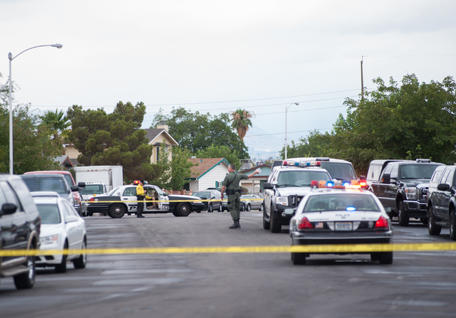 Las Vegas police officers communicate with each other while securing a northeast valley neighborhood in Las Vegas on Sunday, August 3, 2014. (Martin S. Fuentes/Las Vegas Review-Journal)