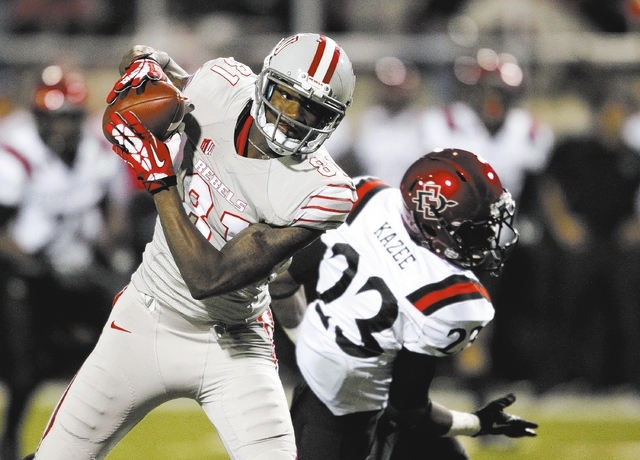 UNLV junior wide receiver Devante Davis makes a catch before scoring a 63-yard touchdown against San Diego State on Nov. 30 at Sam Boyd Stadium. Davis made four TD catches in the game, giving him ...