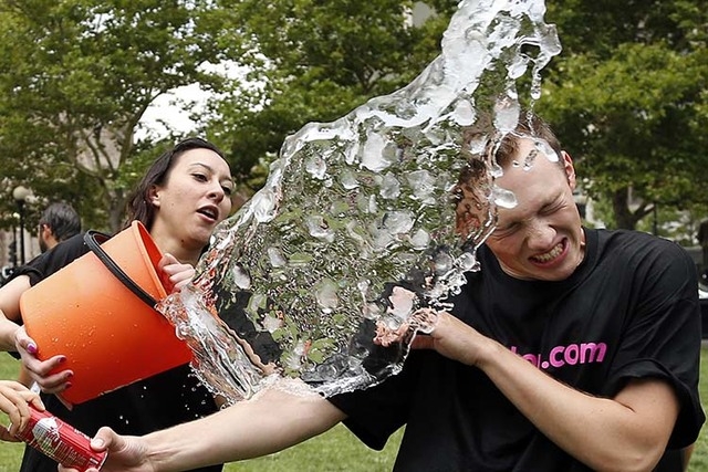 Beryl Lipton, left, douses Matt Lee during the Ice Bucket Challenge at  Boston's Copley Square, Thursday, Aug. 7, 2014, to raise funds and  awareness for ALS. (AP Photo/Elise Amendola) | Las Vegas