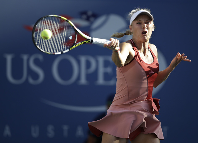 Caroline Wozniacki, of Denmark, returns a shot against Serena Williams during the championship match of the 2014 U.S. Open tennis tournament, Sunday, Sept. 7, 2014, in New York. (AP Photo/Darron C ...
