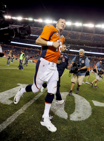 Denver Broncos quarterback Peyton Manning (18) leaves the field after an NFL football game against the Indianapolis Colts, Sunday, Sept. 7, 2014, in Denver. The Broncos won 31-24. (AP Photo/Jack D ...
