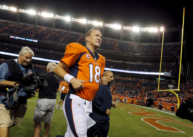 Denver Broncos quarterback Peyton Manning (18) leaves the field after an NFL football game against the Indianapolis Colts, Sunday, Sept. 7, 2014, in Denver. The Broncos won 31-24. (AP Photo/Jack D ...