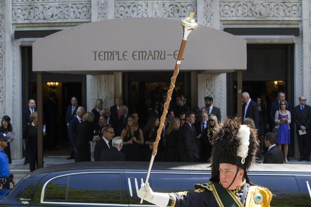 A member of a bagpipe ensemble gestures as mourners depart the funeral of comedian Joan Rivers at Temple Emanu-El in New York September 7, 2014. REUTERS/Lucas Jackson (UNITED STATES - Tags: ENTERT ...