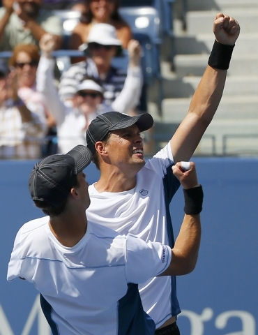 Bob Bryan (rear) and his brother Mike Bryan of the U.S. celebrate after defeating Marcel Granollers and Marc Lopez of Spain in their men's doubles final match at the 2014 U.S. Open tennis tourname ...