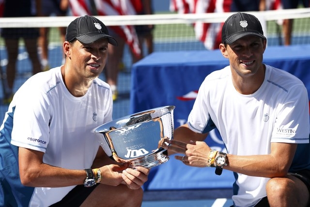 Bob Bryan (L) and his brother Mike Bryan of the U.S. pose with their trophy after they defeated Marcel Granollers and Marc Lopez of Spain in their men's doubles final match at the 2014 U.S. Open t ...