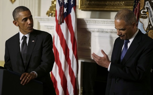 U.S. President Barack Obama, left, turns to Attorney General Eric Holder as he announces Holder's resignation in the White House State Dining Room in Washington, Thursday, Sept. 25, 2014. (Reuters ...