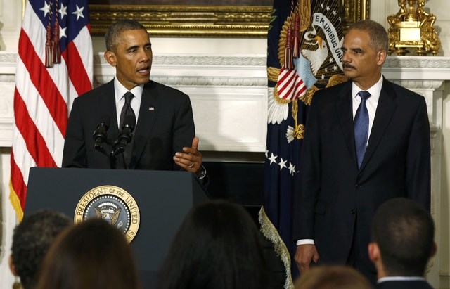 U.S. President Barack Obama, left, announces the resignation of Attorney General Eric Holder in the White House State Dining Room in Washington, Thursday, Sept. 25, 2014. (Reuters/Larry Downing)