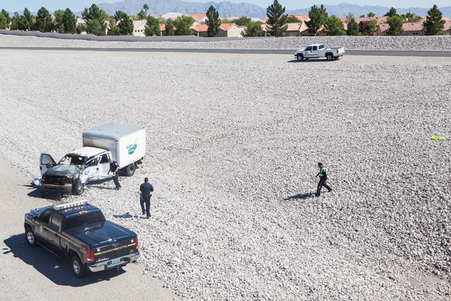 Nevada Highway Patrol investigate a crash involving two landscaping trucks that caused one to catch fire at the Summerlin Parkway and 215 Beltway intersection in Las Vegas on Wednesday, Sept. 17, ...