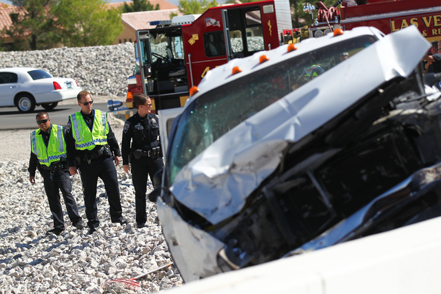 Nevada Highway Patrol officers respond to a crash involving two landscaping trucks that caused one to catch fire at the Summerlin Parkway and 215 Beltway intersection in Las Vegas on Wednesday, Se ...