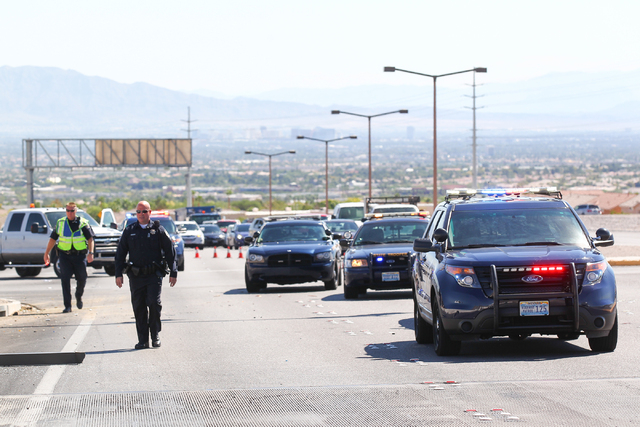 Nevada Highway Patrol officers respond to a crash involving two landscaping trucks that caused one to catch fire at the Summerlin Parkway and 215 Beltway intersection in Las Vegas on Wednesday, Se ...