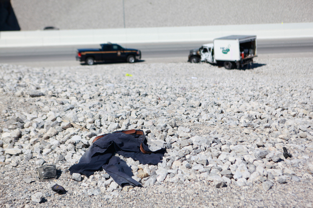 A pair of pants is seen on the ground Nevada Highway Patrol officers respond to a crash involving two landscaping trucks that caused one to catch fire at the Summerlin Parkway and 215 Beltway inte ...