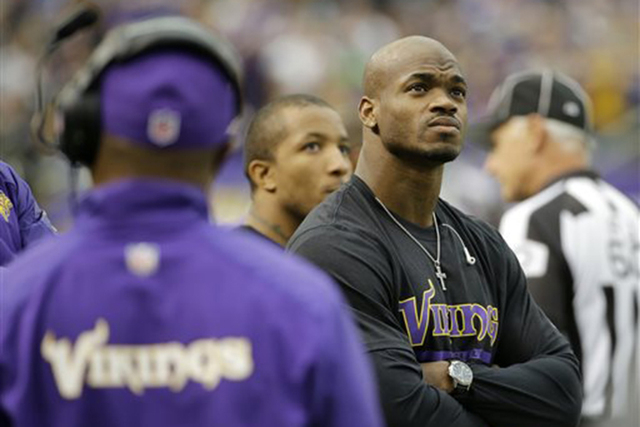 In this Dec. 29, 2013, file photo, Minnesota Vikings running back Adrian Peterson stands on the sidelines during the first half of an NFL football game against the Detroit Lions in Minneapolis.  A ...
