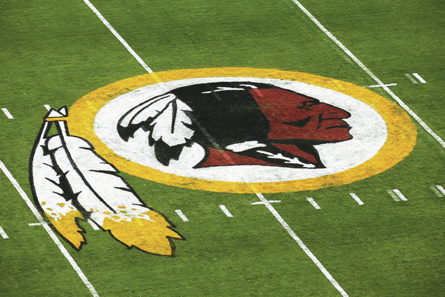The Washington Redskins logo is seen on the field before an NFL football preseason game against the New England Patriots in Landover, Md., Thursday, Aug. 7, 2014. (AP Photo/Alex Brandon)