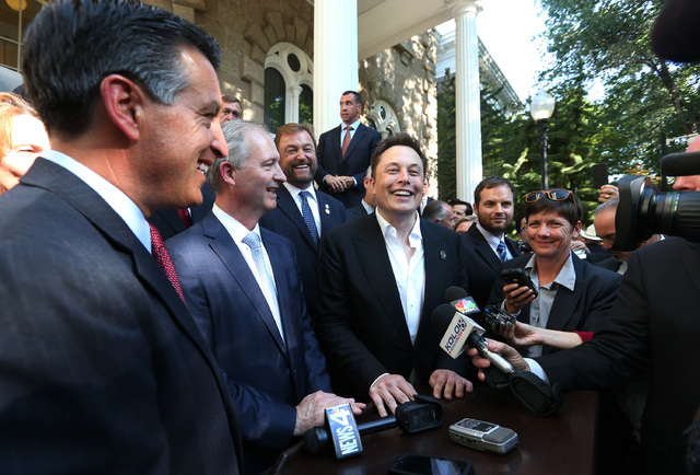 From left, Nevada Gov. Brian Sandoval, Steve Hill, executive director of the Governor's office of economic development, and Telsa Motors CEO Elon Musk answer questions following a news conference ...
