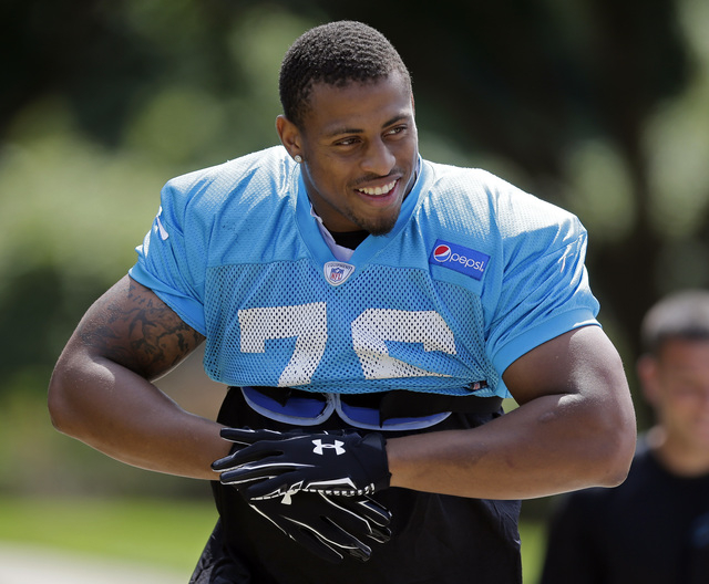 Carolina Panthers' Greg Hardy smiles at fans as he arrives for an NFL football practice in Charlotte, N.C., Thursday, Sept. 11, 2014. Hardy has been convicted on two counts of domestic violence an ...