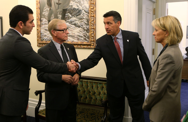 Nevada senators, from left, Ruben Kihuen, David Parks and Barbara Cegavske talk with Gov. Brian Sandoval, right center, at the Capitol in Carson City on Wednesday, Sept. 10, 2014. Sandoval called ...