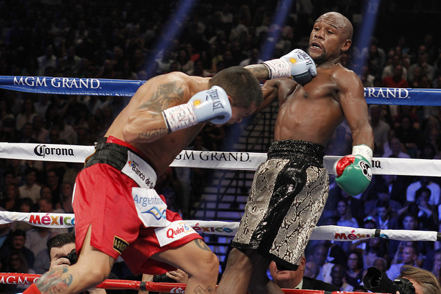 Marcos Maidana connects with Floyd Mayweather Jr. during their WBC/WBA welterweight title fight at the MGM Grand Garden Arena in Las Vegas on Saturday, Sept. 13, 2014. (Sam Morris/Las Vegas Review ...