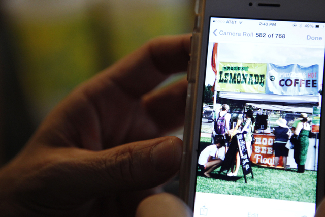 Rock Rocheleau shows a photo of his daughter's lemonade stand at their home in Henderson Saturday, Sept. 6, 2014. Rocheleau's three daughters started a lemonade business in March and have since ma ...