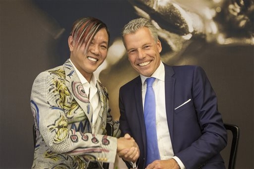 In this Tuesday, Sept. 16, 2014 photo provided by Rolls-Royce Motor Cars, Louis XIII Holdings Ltd. Chairman Stephen Hung, left, poses with Rolls-Royce Motor Cars CEO Torsten Mueller-Oetvoes at the ...
