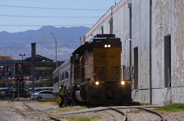 Union Pacific workers prepare a pair of Club X Train cars to be moved from the Las Vegas Review-Journal's parking lot near the intersection of MLK Blvd. and Bonanza Rd. in Las Vegas on Thursday, J ...