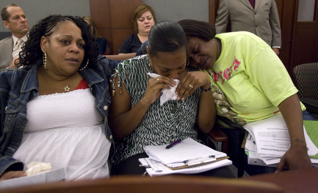 RJ FILE***
K.M. CANNON/LAS VEGAS REVIEW-JOURNAL
Family members of slain suspect Trevon Cole, from left, mother Nichelle Bratton, aunt Kimeryn Williams and aunt Tisha Bell comfort each other as the ...