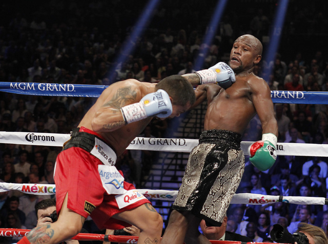 Marcos Maidana connects with Floyd Mayweather Jr. during their WBC/WBA welterweight title fight at the MGM Grand Garden Arena in Las Vegas on Saturday, Sept. 13, 2014. (Sam Morris/Las Vegas Review ...