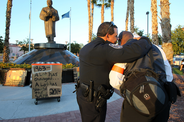 North Las Vegas Police Lt. Wilson Crespo, left, and organizer Rodney Smith talk before a peace rally and vigil Aug. 28 for Michael Brown at the Martin Luther King Jr. statue on the corner of North ...