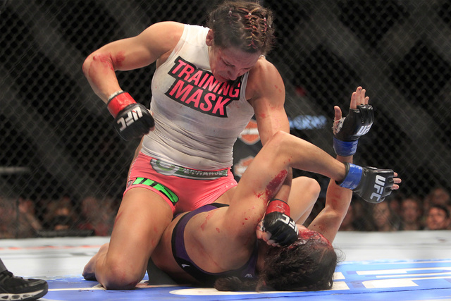 Cat Zingano pounds on Amanda Nunes on her way to a third round TKO during their fight at UFC 178 Saturday, Sept. 27, 2014 at the MGM Grand Garden Arena in Las Vegas. (Sam Morris/Las Vegas Review-J ...