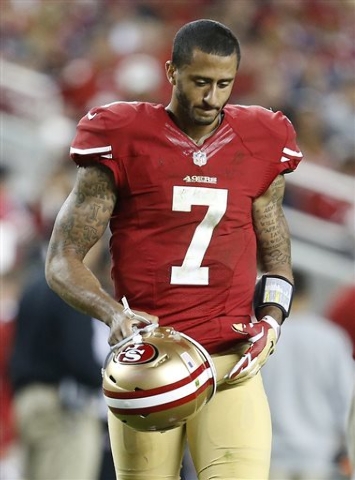 San Francisco 49ers quarterback Colin Kaepernick (7) walks on the field during the fourth quarter of an NFL football game against the Chicago Bears in Santa Clara, Calif., Sunday, Sept. 14, 2014. ...