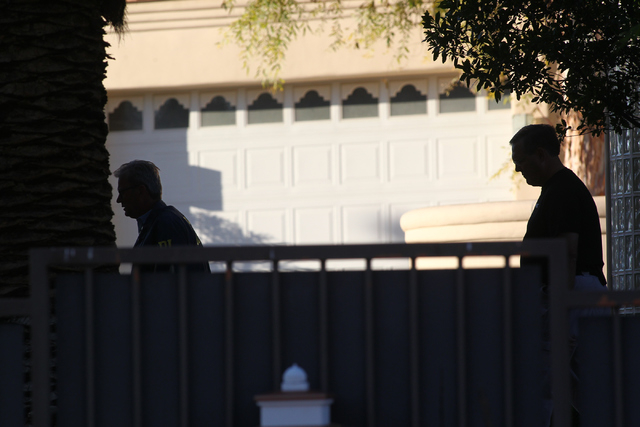 FBI agents investigate while serving a federal search warrant at a home at 4311 E. Oquendo Road in Las Vegas on Monday, Sept. 29, 2014. The FBI did not give any other details other than that no ar ...