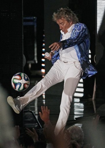 In this Feb. 27, 2014, file photo, singer Rod Stewart kicks a soccer ball to the crowd as he performs at the Vina del Mar International Song Festival in Vina del Mar, Chile. A soccer ball kicked i ...