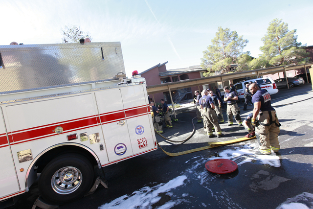 Firefighters clean up after responding to a fire that left one man dead in an apartment complex on 2825 Bluegrass Lane in Henderson on Tuesday, Sept. 30, 2014. (Chase Stevens/Las Vegas Review-Jou ...