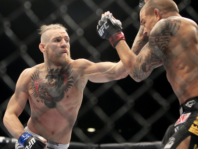 Conor McGregor hits Dustin Poirier with a left during their fight at UFC 178 Saturday, Sept. 27, 2014 at the MGM Grand Garden Arena in Las Vegas. (Sam Morris/Las Vegas Review-Journal)